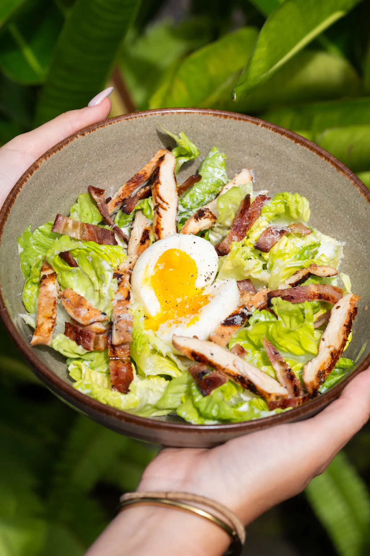 Caesar salad with grilled chicken, bacon and soft egg