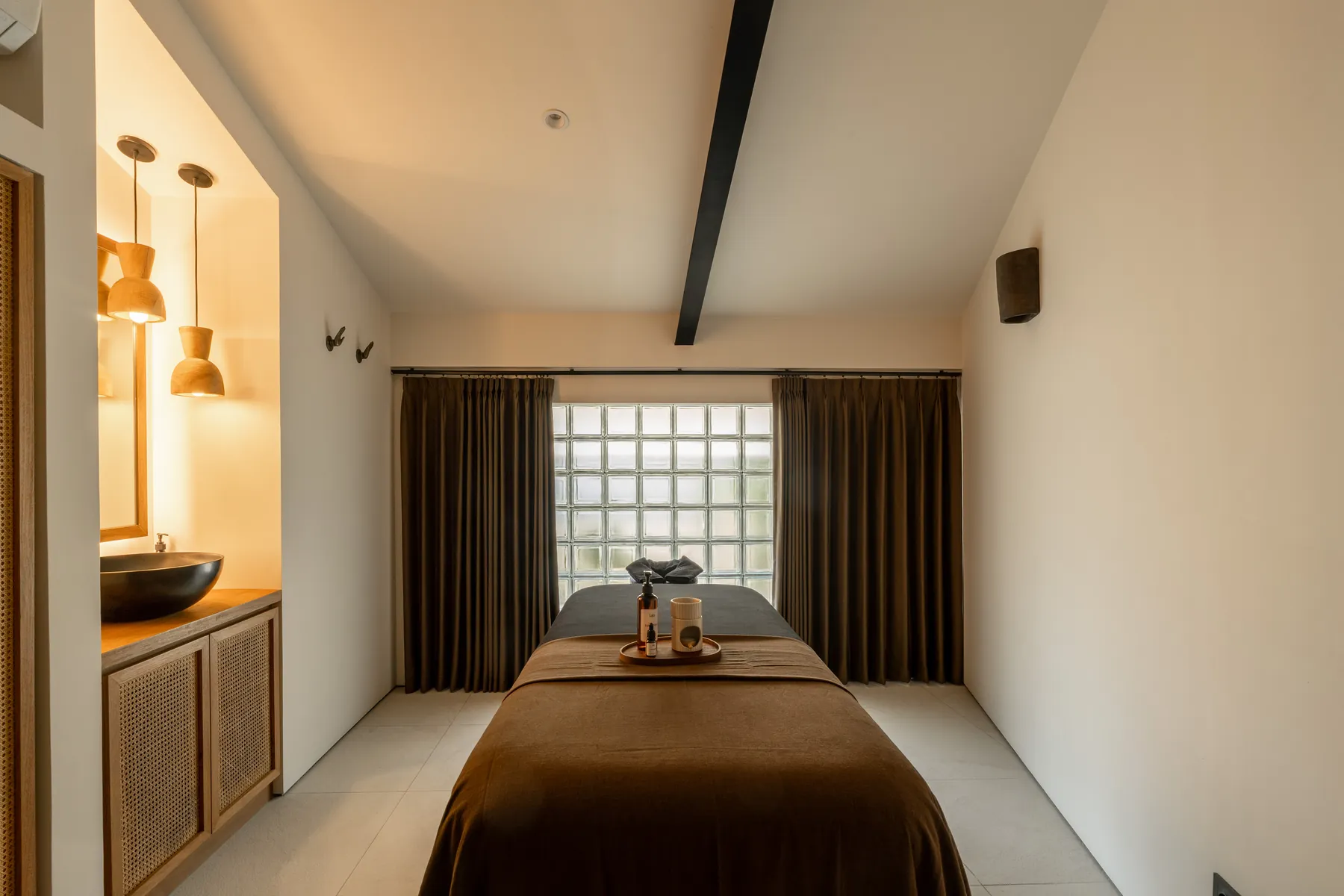Treatment room with massage bed and glass block window